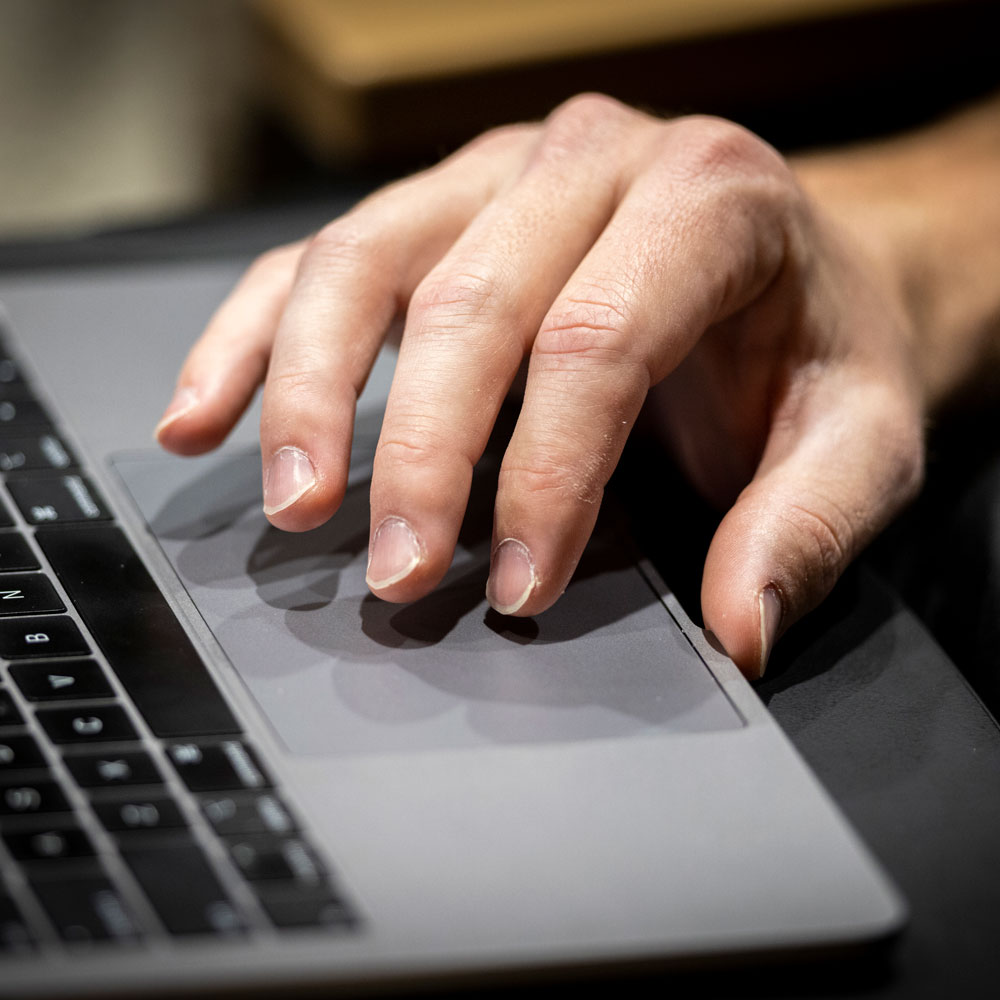 hand on laptop keyboard