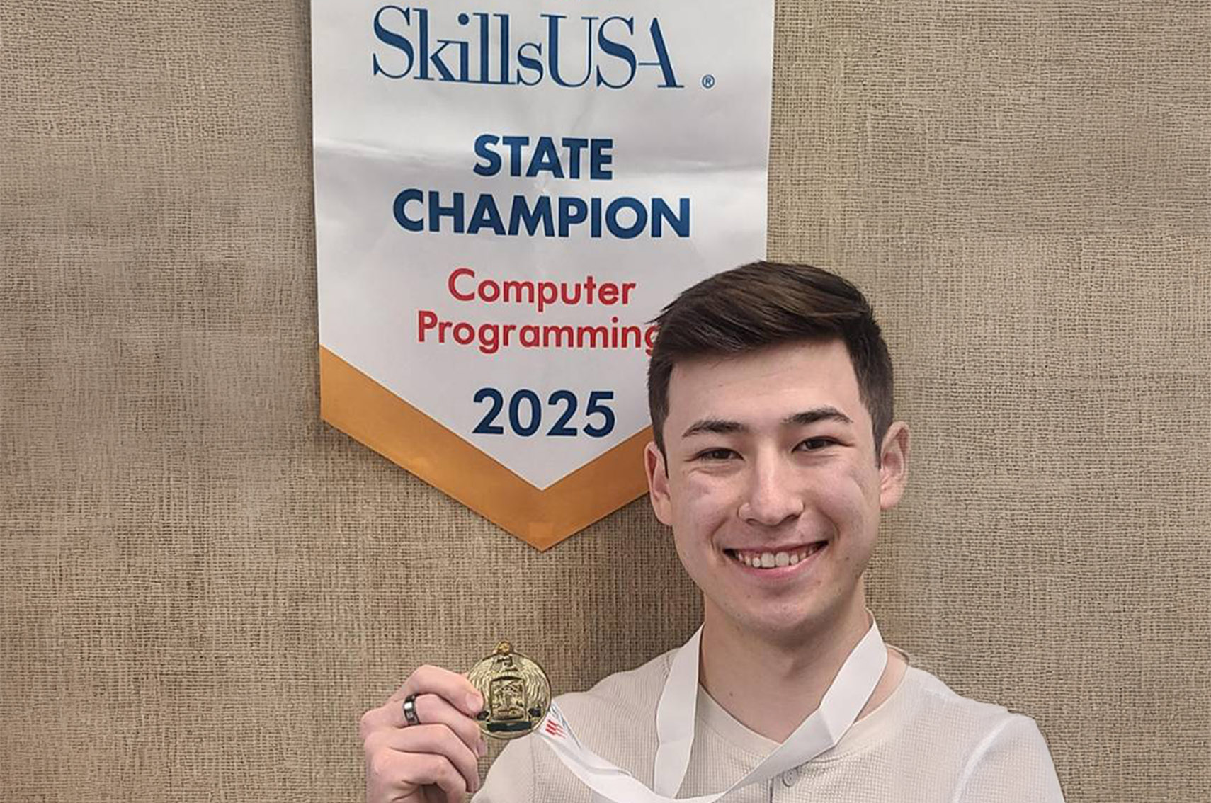 1st place winner Christopher holding medal