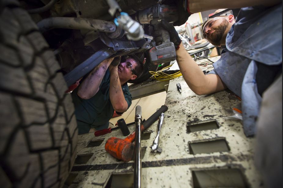 student works on a car