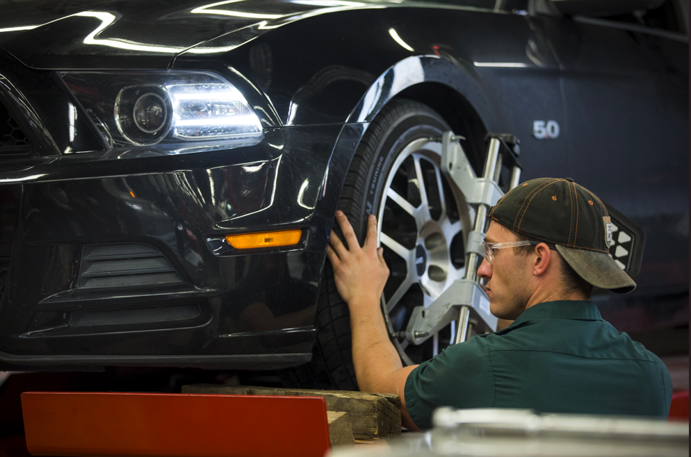 student works on car