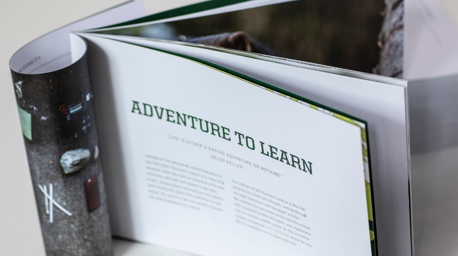 Printed brochure open to page with text "Adventure to Learn."