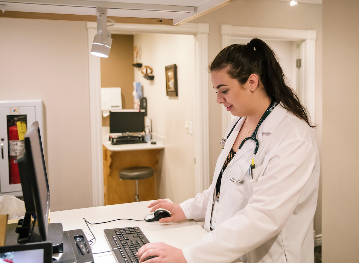 Doctor taking notes on a computer
