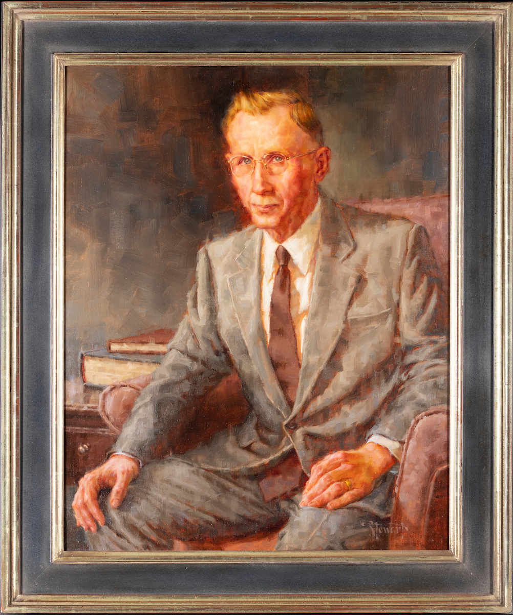 Portrait of Hyrum E. Johnson, painted by Perry Stewart. In the portrait Johnson is depicated as being seated in front of a dark background. A side table with books on it is next to the chair that Johnson is in.