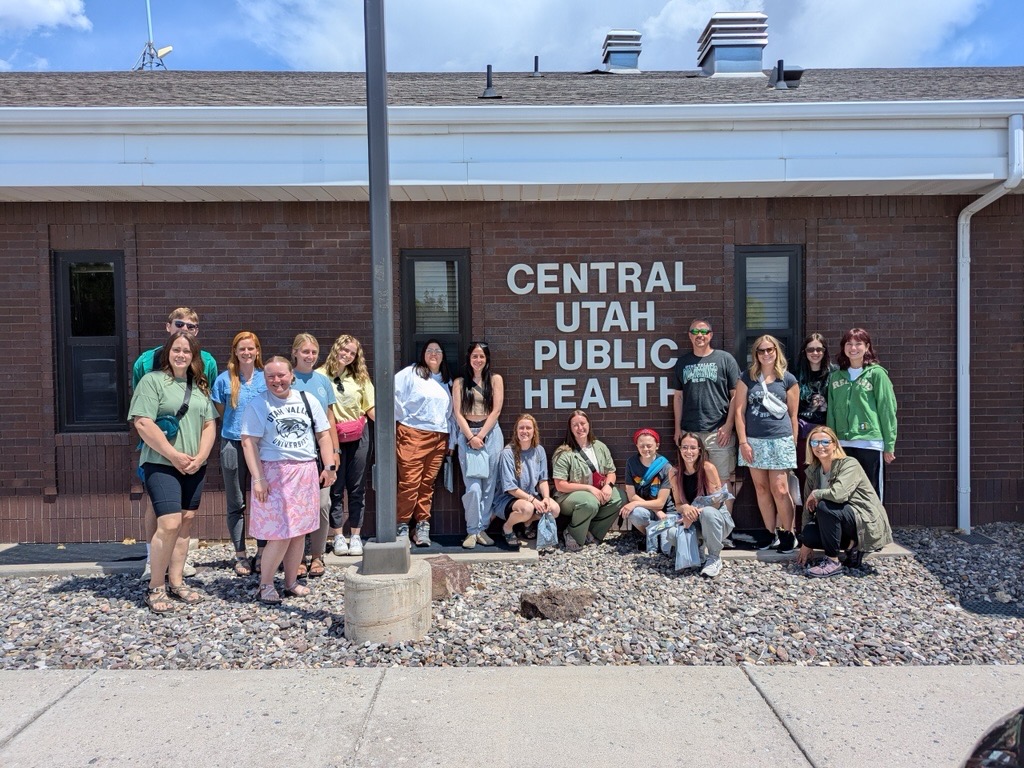 Public Health, Minor. Woman taking vitals of man in hat.
