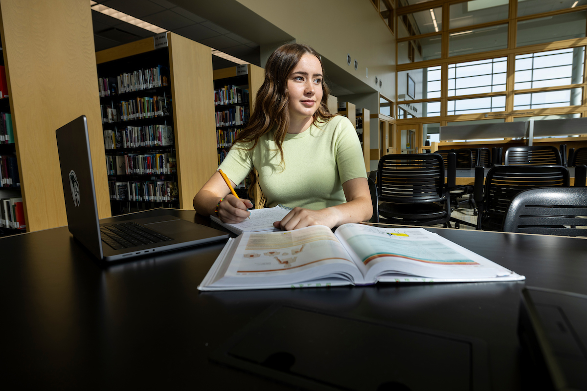 student studying in the library