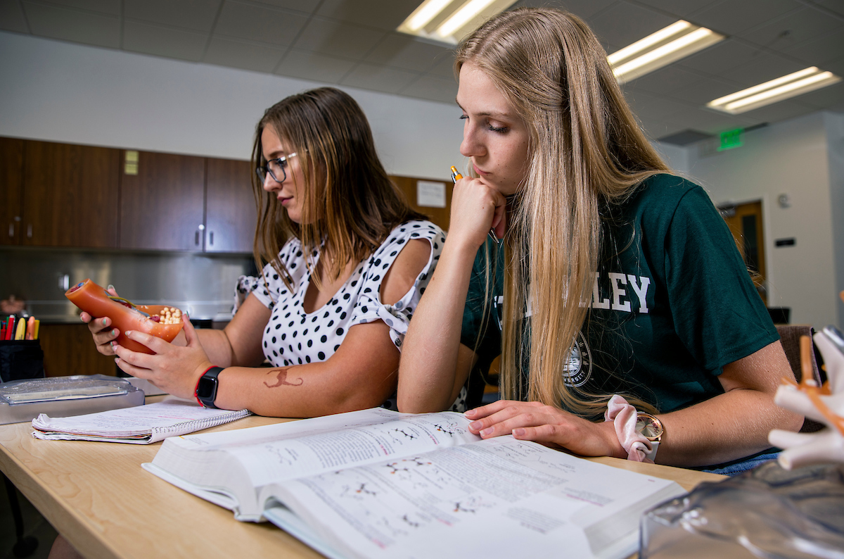 student looking through their handwritten notes