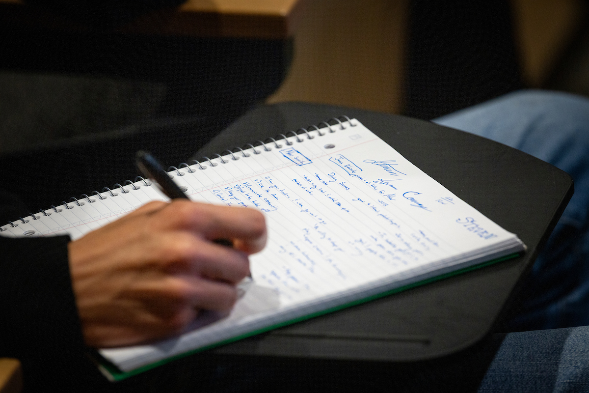 Person writing on a piece of paper