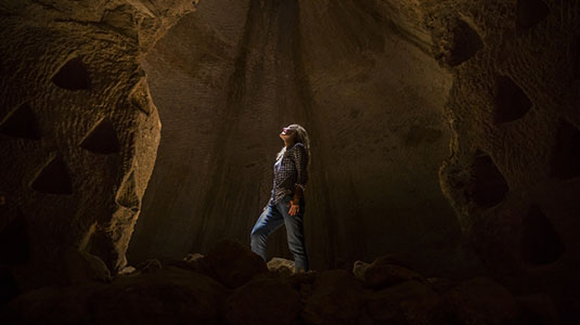 woman standing in a cave