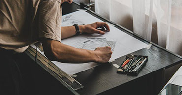 person using a drafting table