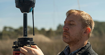 man using surveying equipment