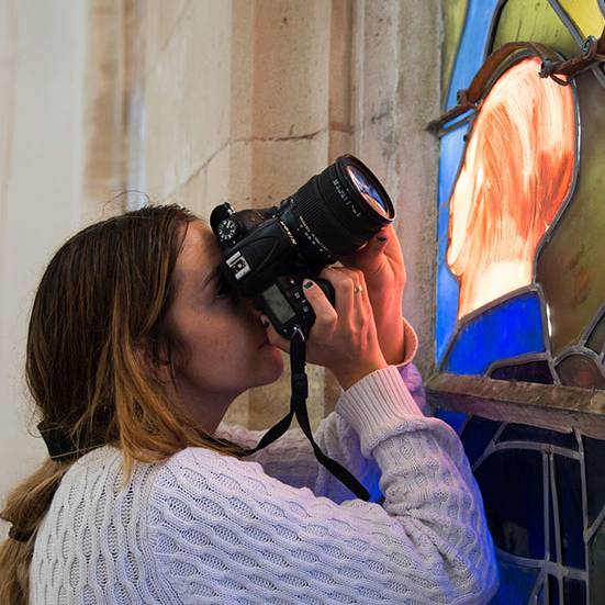 Girl taking a photo of stained glass