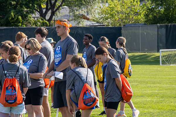 Image of a group of kids and some adult volunteers  outdoors