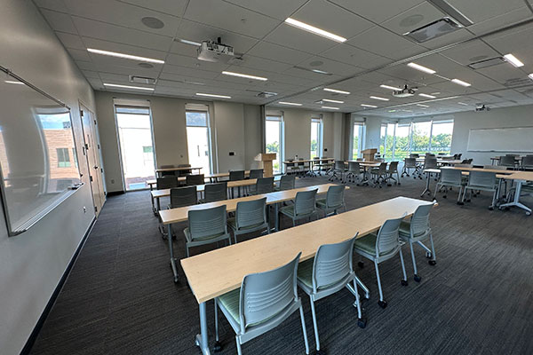 MNCA training room with desks and a podium