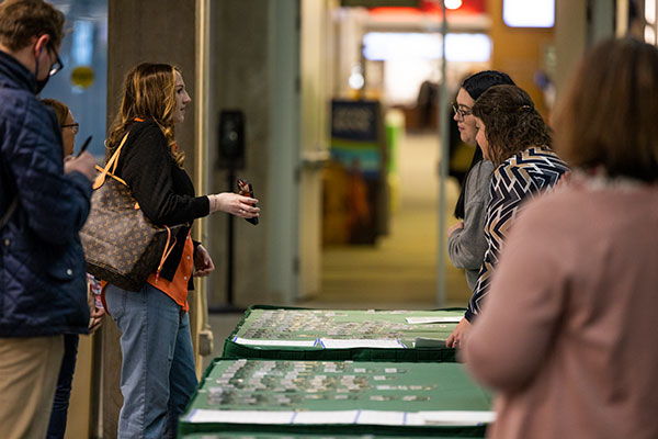 People handing out maps and flyers at an event