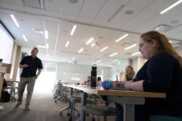 people in a classroom listening to a presentation