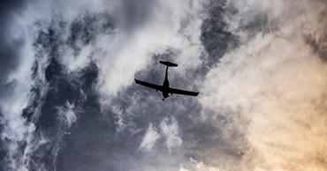 On the ground view of airplane flying overhead