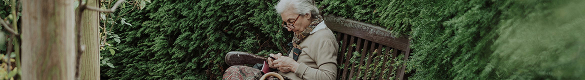 an older woman sitting on a bench
