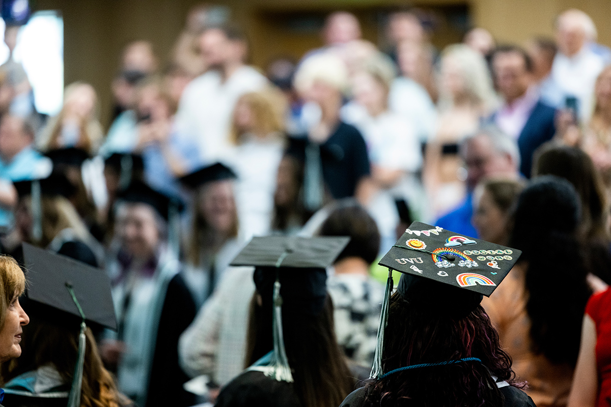 Graduates with their caps on, some of them decorated