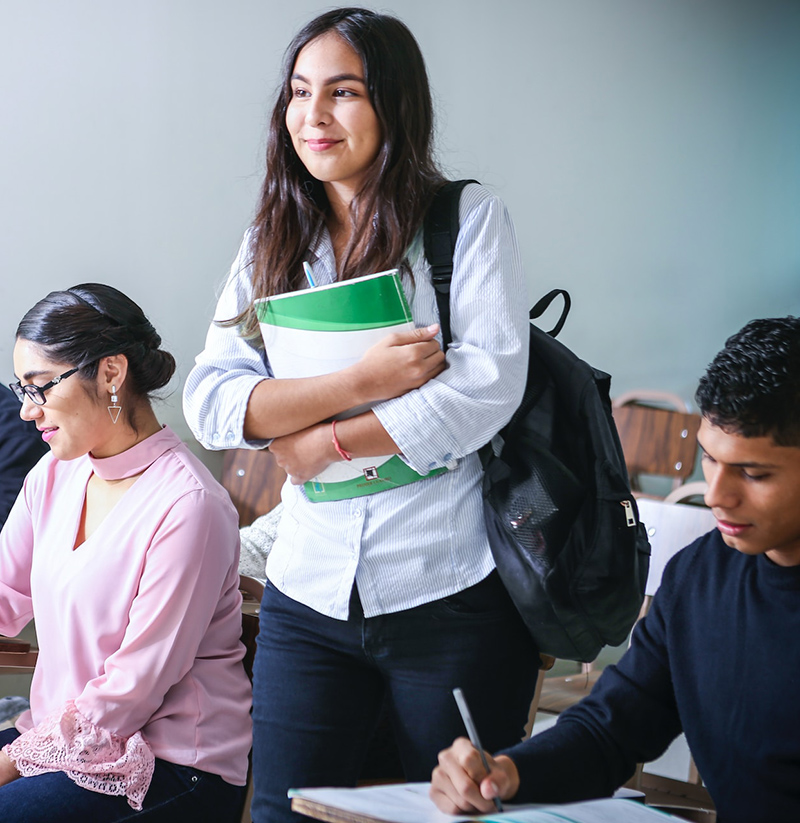 girl in class holding a notebook