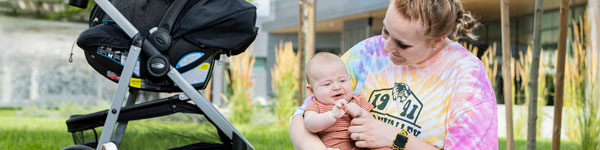 A UVU student parent with their baby on campus