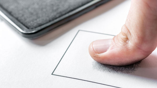 A childcare provider being fingerprinted