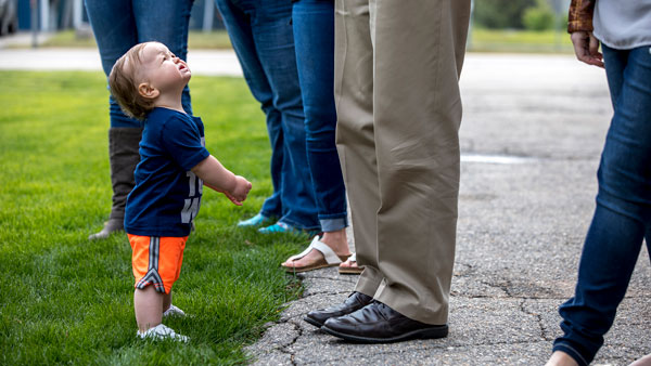 A child looking up at their childcare providers