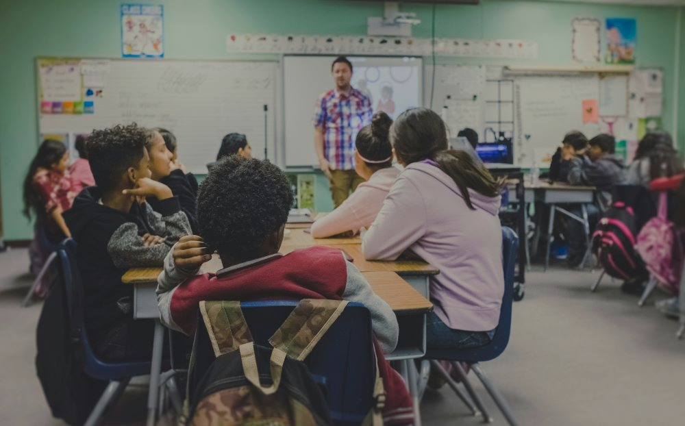 Teacher in a classroom full of students