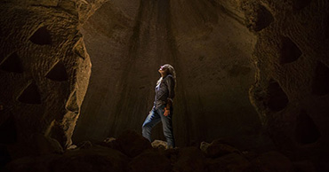 woman standing in a cave