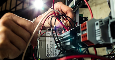 close up of hands working on wiring