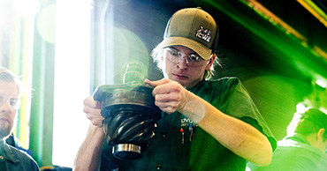 student working with a large car part