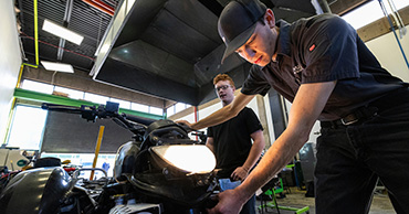 students working on a motorcycle