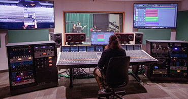 student using an audio editing station