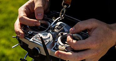 close up of hands using a drone controller