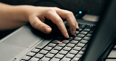 close up of a hand on a laptop keyboard