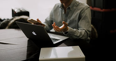 man sitting at a laptop