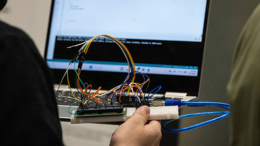 students working with an circuit board