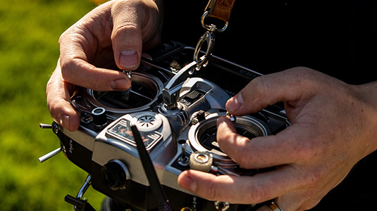 close up of hands using a drone controller