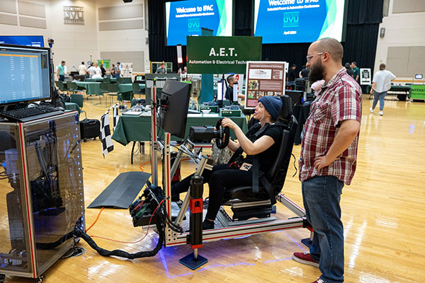 student demonstrating driving simulator project