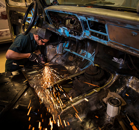 man welding a car