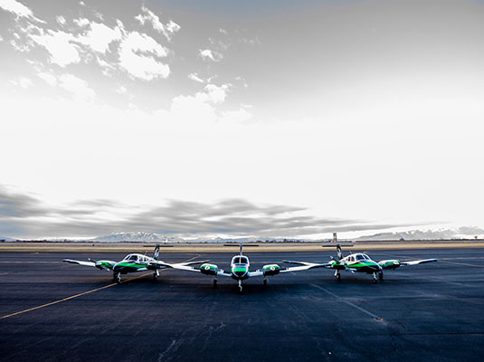 three planes on a runway