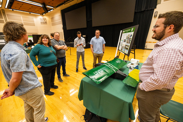 group of people standing around a table