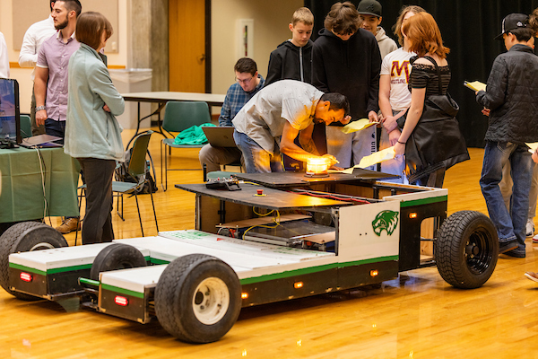 student working on a car