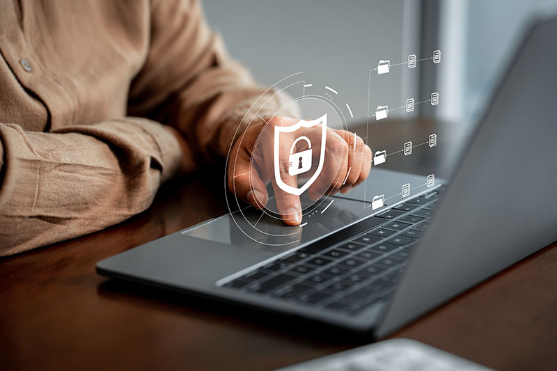 person using a laptop with a lock icon hovering over it