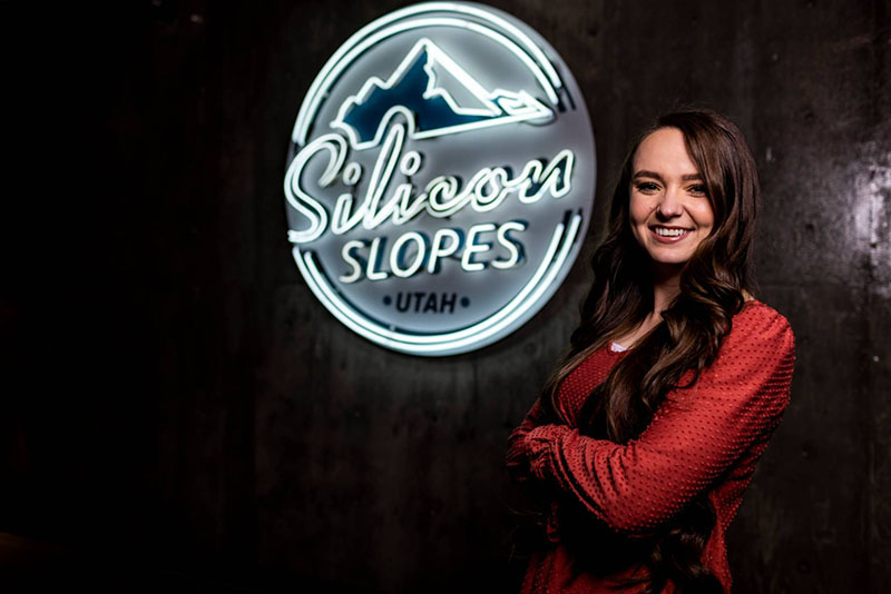 girl in front of a silicon slopes sign