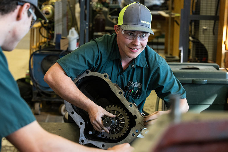 students working on car parts