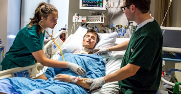 man and woman doing respiratory work on a man