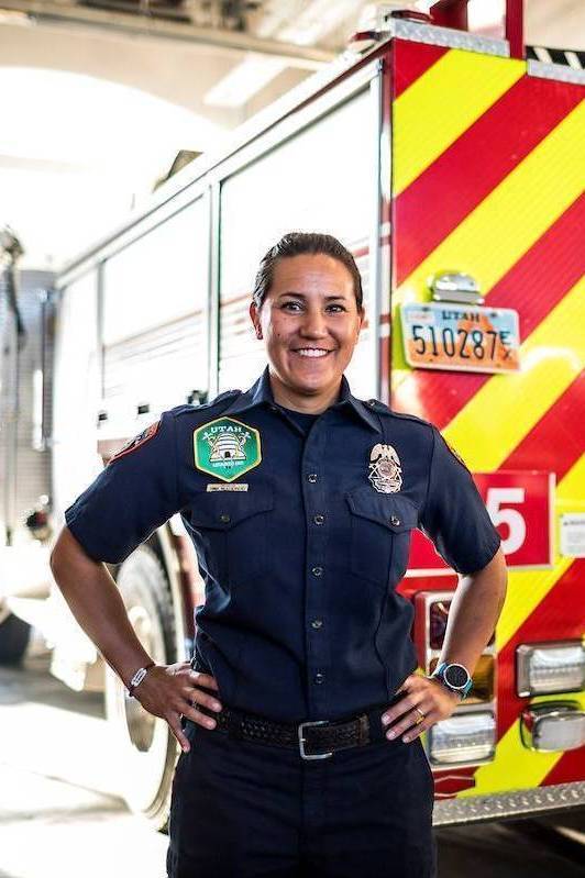 Female EMT standing in front of an ambulance