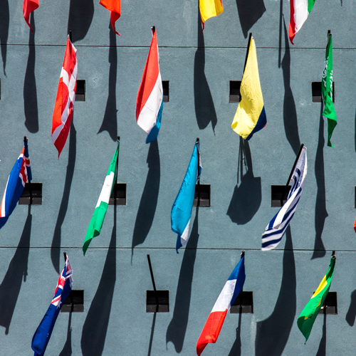 international flags hanging from a wall