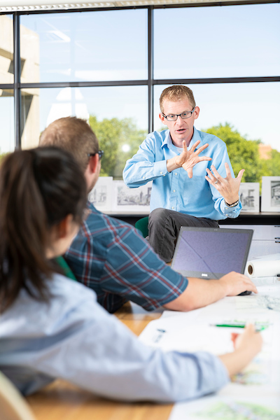 Advisor working with students in a classroom