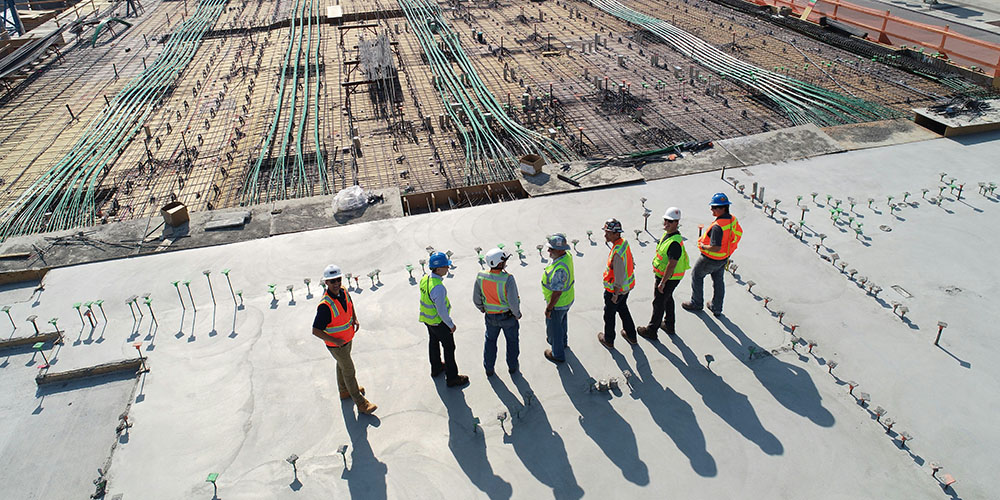 a group of construction workers overlooking a construction site